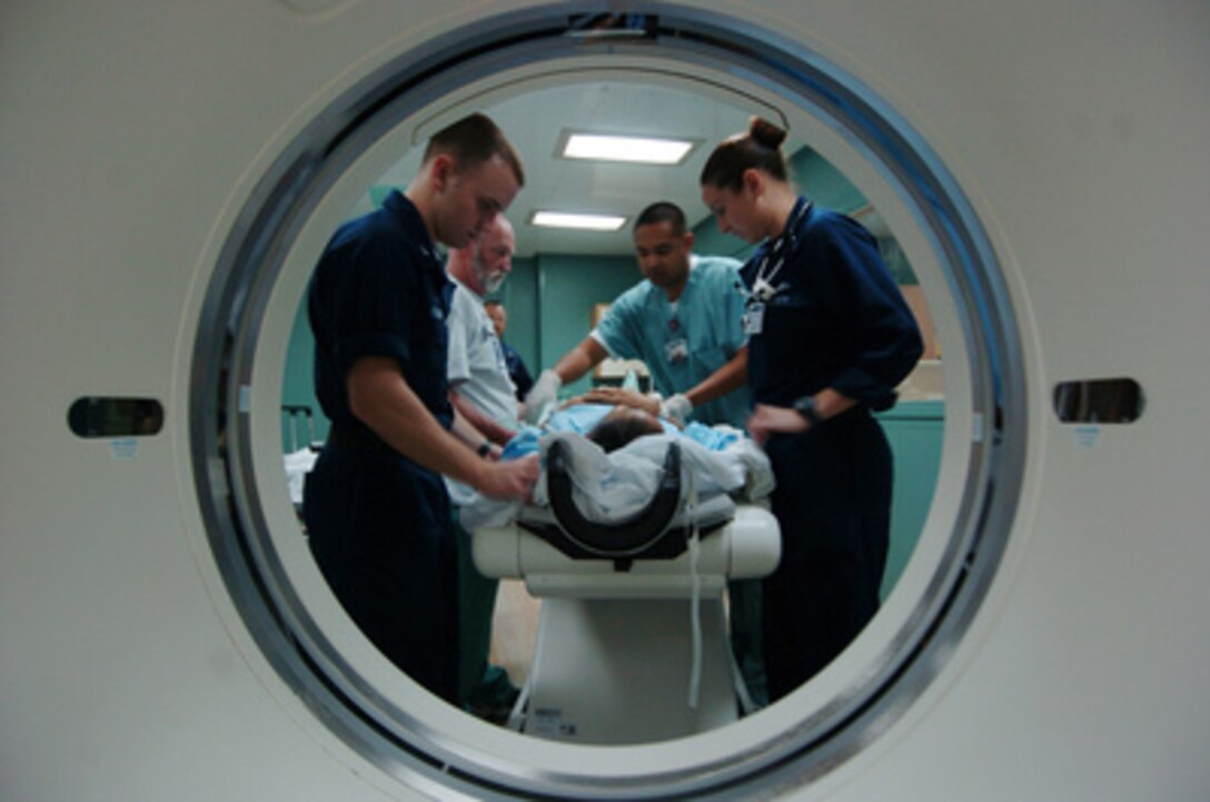 Military medical professionals and Project HOPE volunteers prepare an Indonesian patient for a Computed Axial Topography or CAT scan onboard the hospital ship USNS Mercy (T-AH 19) on Feb 14, 2005. Mercy is operating off the coast of Banda Aceh, Sumatra, Indonesia, to provide medical assistance and disaster relief to the people of Indonesia affected by the devastating tsunami that hit Southeast Asia on Dec. 26, 2004. 