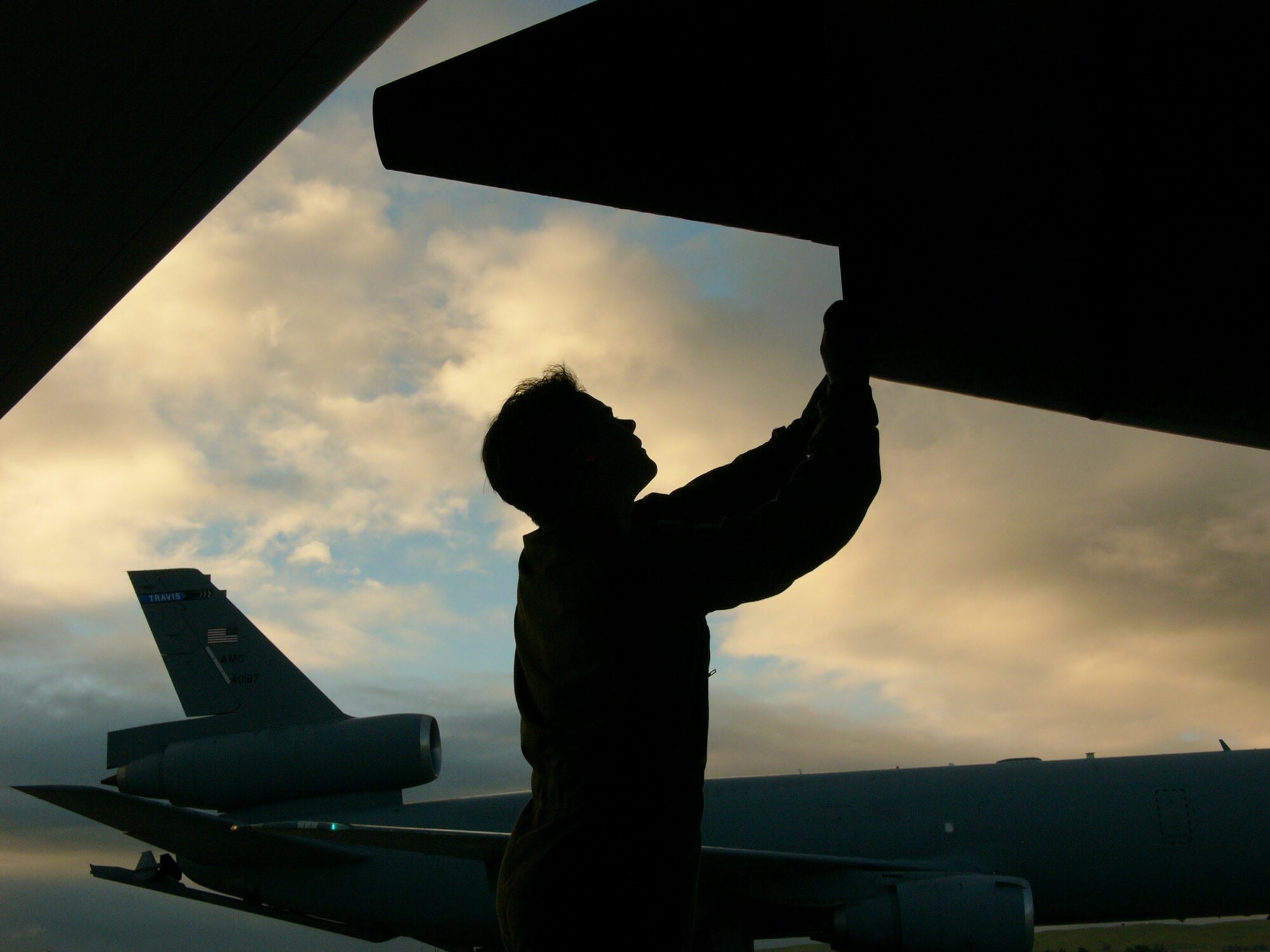 TRAVIS AIR FORCE BASE, Calif. -- Master Sgt. Eric Sherman inspects the exhaust nozzle on a KC-10 Extender engine.  The aircraft is assigned to the Air Force Reserve Command's 349th Air Mobility Wing.  Sergeant Sherman is a flight engineer assigned to the 70th Air Refueling Squadron.  (U.S. Air Force photo by Master Sgt. Lance Cheung) 