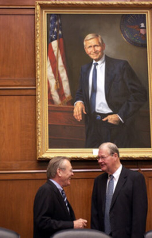 Secretary of Defense Donald H. Rumsfeld (left) and Rep. Ike Skelton (D-Mo.) talk informally before a House Armed Services Committee hearing in the Rayburn House Office Building in Washington, D.C., on Feb. 16, 2005. Chairman of the Joint Chiefs of Staff Gen. Richard B. Myers, U.S. Air Force, and Under Secretary of Defense Comptroller Tina Jonas joined Rumsfeld in testifying before the committee. 