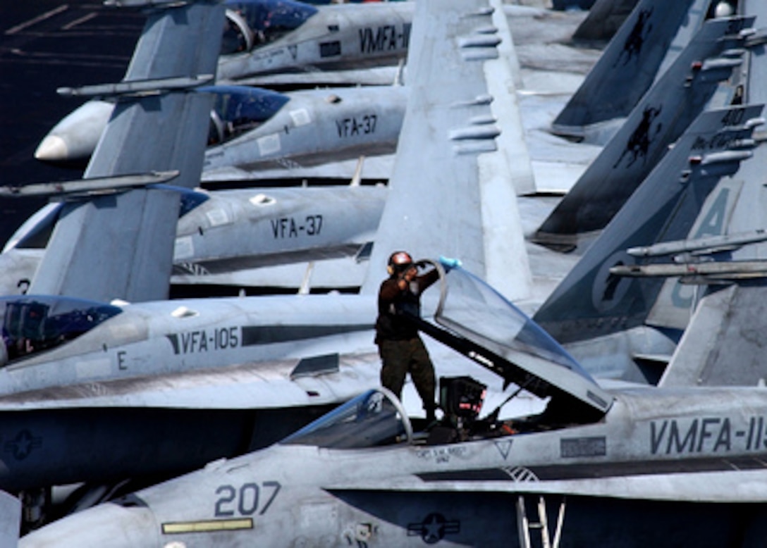 Marine Cpl. Rodger Lagrange cleans the canopy of a Marine F/A-18A+ Hornet onboard the USS Harry S. Truman (CVN 75) while the aircraft carrier operates at sea on Feb. 14, 2005. The Truman Strike Group and Carrier Air Wing 3 are conducting close air support, intelligence, surveillance, and reconnaissance missions over Iraq. Lagrange is attached to Marine Fighter Attack Squadron 115 deployed from Marine Corps Air Station Beaufort, S.C. 