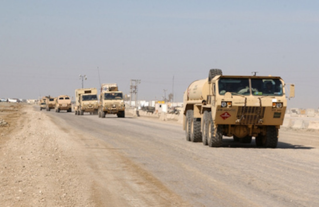 Vehicles from the Army's 3rd Infantry Division form a convoy as they depart Camp Cedar II in central Iraq bound for Kuwait on Feb. 16, 2005. 