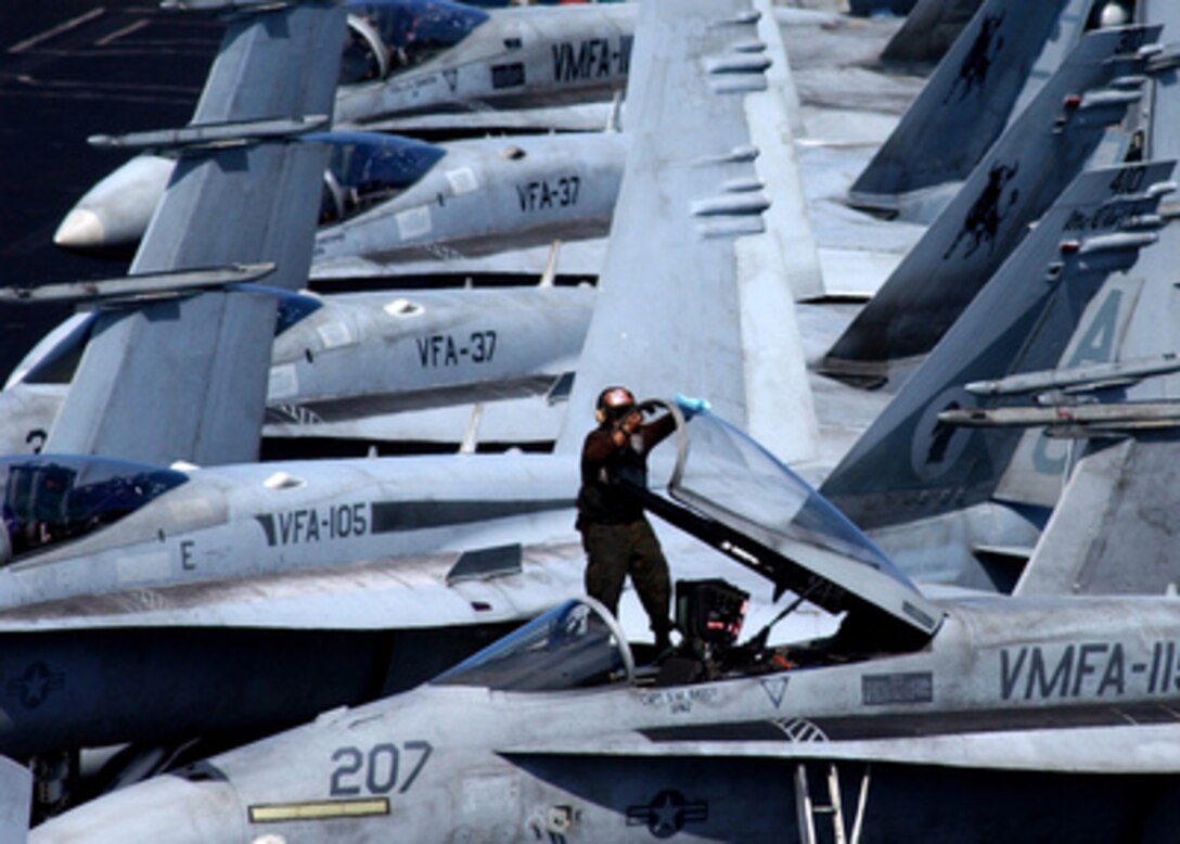 Marine Cpl. Rodger Lagrange cleans the canopy of a Marine F/A-18A+ Hornet onboard the USS Harry S. Truman (CVN 75) while the aircraft carrier operates at sea on Feb. 14, 2005. The Truman Strike Group and Carrier Air Wing 3 are conducting close air support, intelligence, surveillance, and reconnaissance missions over Iraq. Lagrange is attached to Marine Fighter Attack Squadron 115 deployed from Marine Corps Air Station Beaufort, S.C. 