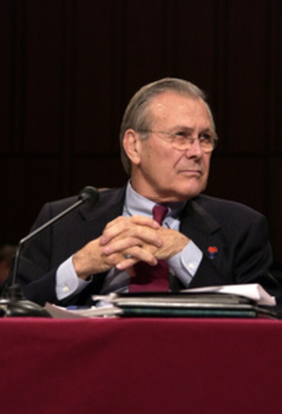 Secretary of Defense Donald H. Rumsfeld listens as Chairman of the Joint Chiefs of Staff Gen. Richard B. Myers, U.S. Air Force, answers a senator's question during a Senate Armed Services Committee hearing in the Hart Senate Office Building in Washington, D.C., on Feb. 17, 2005. Myers and Under Secretary of Defense Comptroller Tina Jonas joined Rumsfeld in testifying before the committee. 