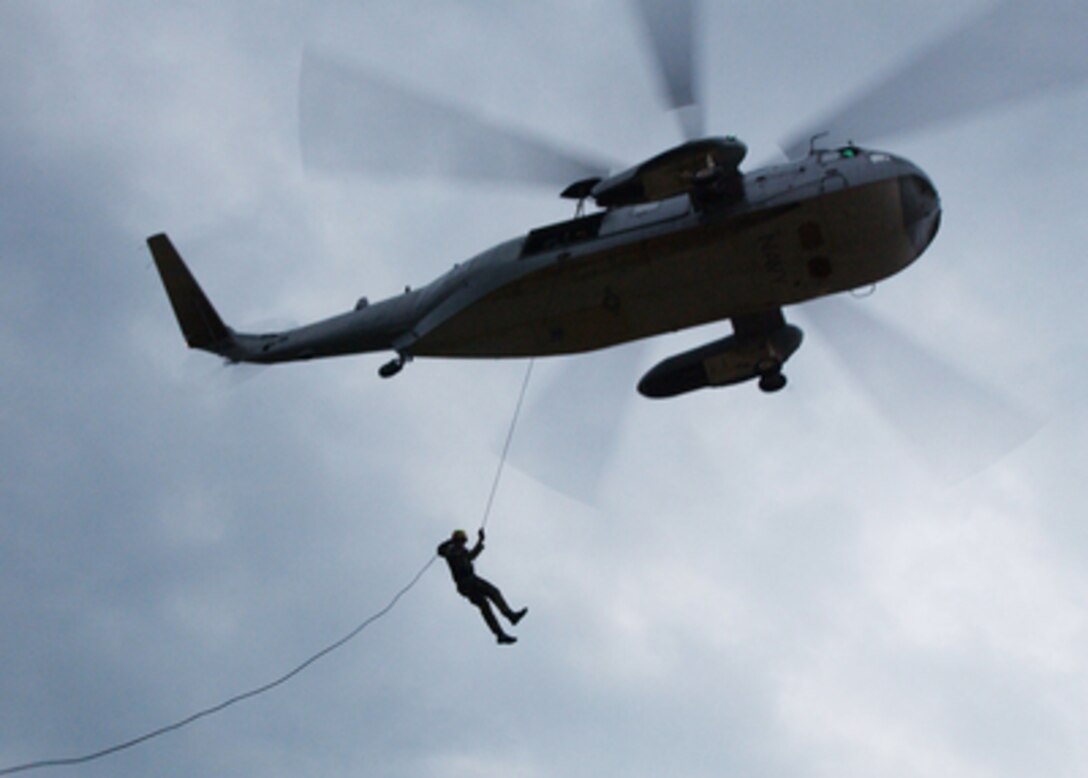 A member of the Navy's Explosive Ordnance Disposal Mobile Unit 2 rappels out of a UH-3H Sea King helicopter during a rappelling and fast rope exercise at Naval Amphibious Base Little Creek, Va., on Feb. 16, 2005. The Sea King is attached to Helicopter Combat Support Squadron 2, Naval Air Station, Norfolk, Va. 