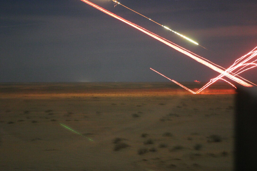 UDAIRI RANGE, Kuwait (Feb. 18, 2005) -- A tow missile and several tracer rounds are fired from a AH-1W Super Cobra helicopter during a live-fire exercise here. The Super Cobra, attached to Marine Medium Helicopter Squadron 165 (REIN) and part of 15th Marine Expeditionary Unit (Special Operations Capable), is training in Kuwait to maintain their combat readiness.
