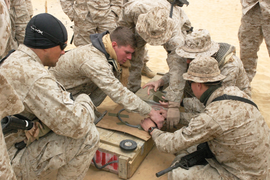 UDAIRI RANGE, Kuwait (Feb. 18, 2005) -- Marines work together to make a flex linear shape charge as part of their demolitions training. The Marines, attached to the 15th Marine Expeditionary Unit (Special Operations Capable) recently underwent demo training to better understand explosives and their capabilities. The 15th MEU (SOC) is training in Kuwait to maintain their combat readiness.