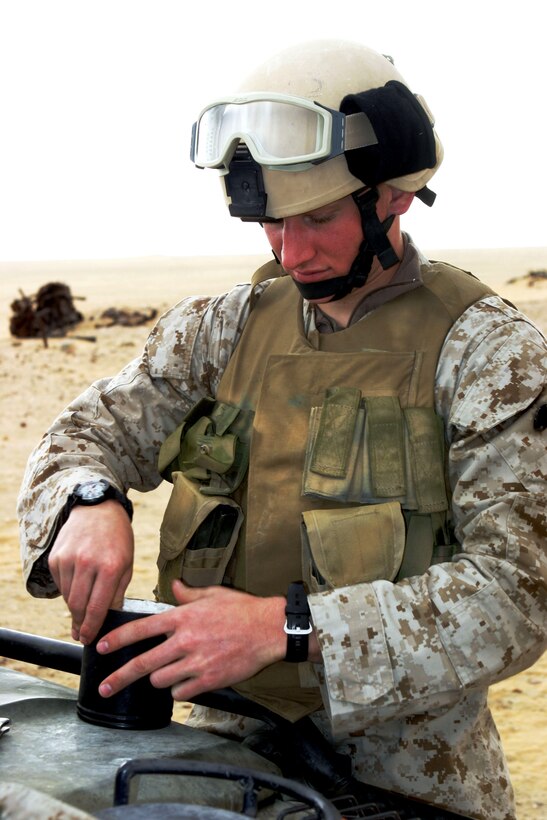 Cpl. Andrew F. Siler, 21, a reconnaissance Marine with Battalion Landing Team 1/1's Recon Platoon, and a native of Coldwater, Mich., packs a metal canister with Composition 4 explosives as part of his demolitions training. Marines underwent the training to better understand explosives and their capabilities. BLT 1/1, attached to the 15th Marine Expeditionary Unit (Special Operations Capable), is training in Kuwait to maintain their combat readiness.