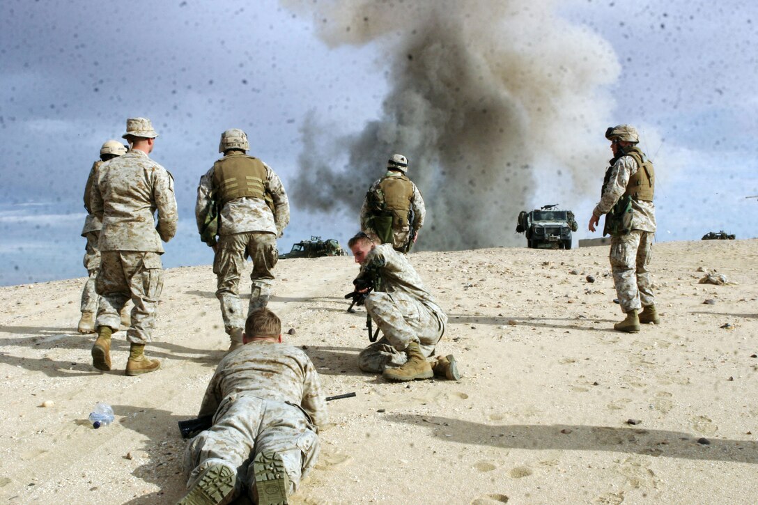 UDAIRI RANGE, Kuwait (Feb. 18, 2005) -- Marines attached to the 15th Marine Expeditionary Unit (Special Operations Capable), stand clear of an explosion during demolitions training. The Marines took part in the training to better understand explosives and their capabilities. The 15th MEU (SOC) is training in Kuwait to maintain their combat readiness.