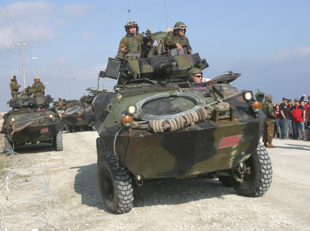 Marines of the Light Armored Reconnaissance platoon, 2d Battalion, 8th Marines, 26th Marine Expeditionary Unit, maneuver Light Armored Vehicles into a security perimeter during the Non-Combatant Evacuation Operation exercise (NEO) Feb. 22 on Onslow Beach, Camp Lejeune, NC. The NEO is part of the 26th MEU's Certification Exercise, which when completed will earn the unit the title "Special Operations Capable." The exercise will bring a close to the MEU's six months of training in preparation for deployment in March. (USMC photo by Cpl. Eric R. Martin).