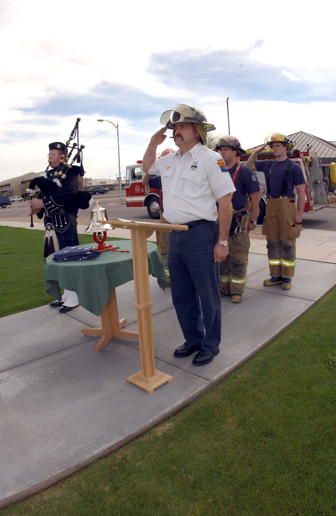 LUKE AIR FORCE BASE, Ariz. -- Assistant Fire Chief Steve Kinkade leads firefighters here during a one-minute "final alarm" ceremony Feb. 16 honoring Staff Sgt. Ray Rangel who died while attempting to rescue two Soldiers after their Humvee overturned in a canal in Iraq.  (U.S. Air Force photo by Airman 1st Class Teri Smith)