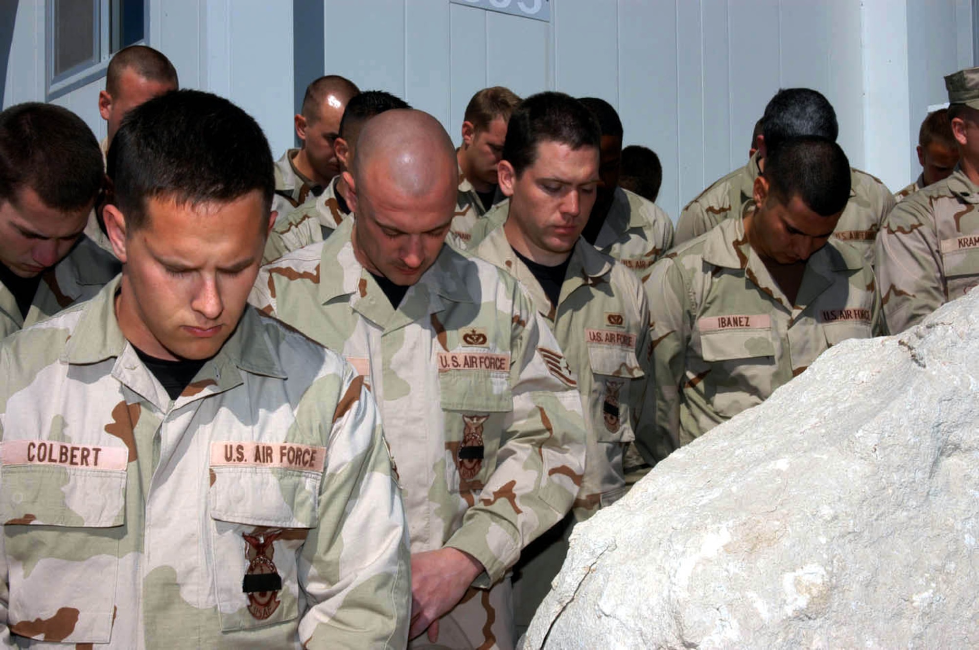 SOUTHWEST ASIA -- Firefighters here pray during a one-minute "final alarm" ceremony Feb. 16 honoring Staff Sgt. Ray Rangel who died while attempting to rescue two Soldiers after their Humvee overturned in a canal in Iraq.  (Courtesy photo)