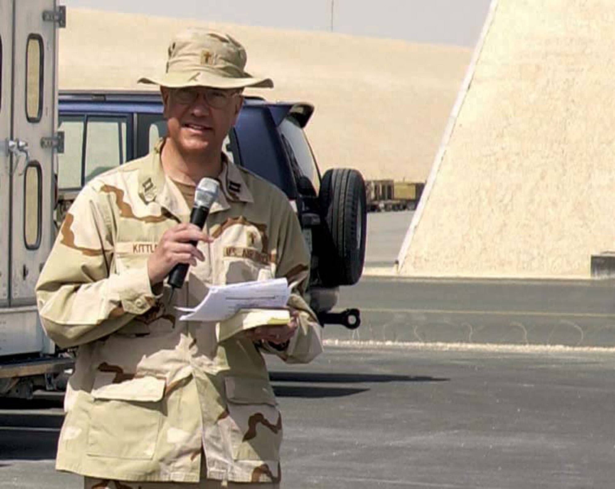 SOUTHWEST ASIA -- Chaplain (Capt.) Larry Kittle reads during a memorial service at a forward deployed location here Feb. 16.  Chaplain Kittle is a 379th Air Expeditionary Wing chaplain deployed from Royal Air Force Lakenheath, England.  (U.S. Air Force photo by Senior Master Sgt. John Snow)