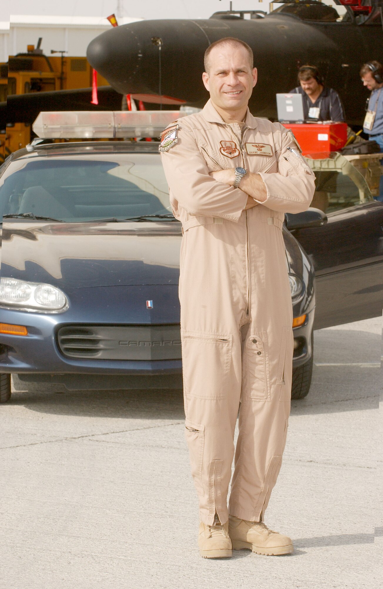 SOUTHWEST ASIA -- Maj. Shane Johnson stands in front of one of the Chevrolet Camaro Z-28s used to chase a U-2 Dragon Lady during takeoffs and landings.  Because of visibility limitations when on the ground, U-2 pilots rely on the driver in the car to provide information during takeoffs and landings.  (U.S. Air Force photo by Staff Sgt. Justin Jacobs)