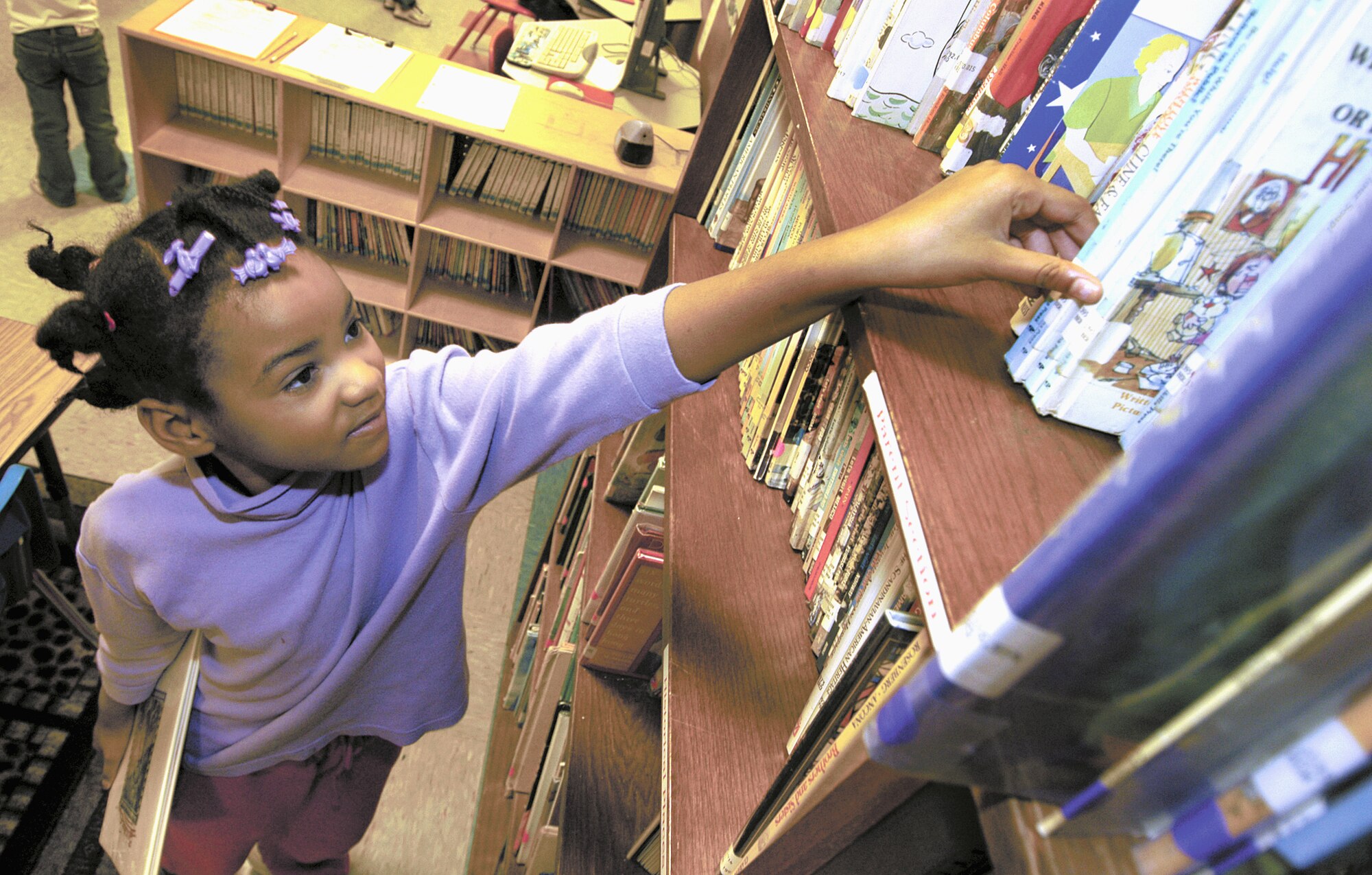 TINKER AIR FORCE BASE, Okla. -- Lareign Murphy, 6, loves to read and admits she likes Dr. Seuss stories the best.  With high participation levels, young readers helped the youth center here earn new books.  (U.S. Air Force photo by Margo Wright)