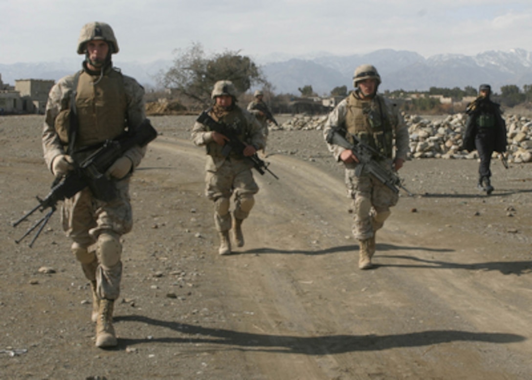 U.S. Marines patrol a road in Khowst Province, Afghanistan, on Feb. 13, 2005. The Marines are assigned to Headquarters and Service Company, 3rd Battalion, 3rd Marines, and are conducting security and stabilization operations in the province. 