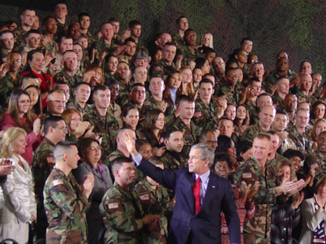 President George W. Bush waves to U.S. service members, civilian employees and spouses assembled at Wiesbaden Army Airfield, Germany, on Feb. 23, 2005. Bush took time out of his five-day visit with European leaders to address and thank military personnel stationed in and around Wiesbaden. 