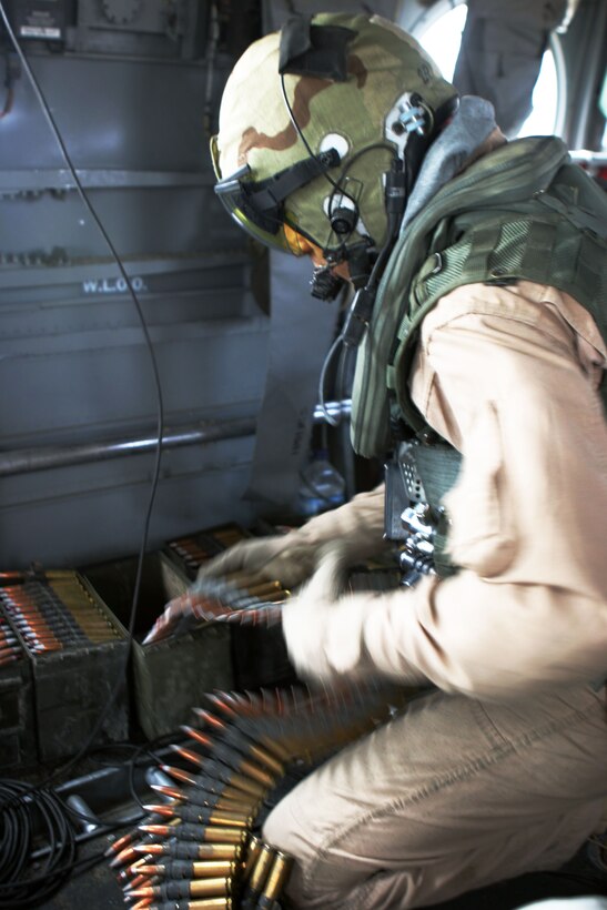 Gunnery Sgt. Lonnie L. Shaw, 32, a CH-46E crew chief with Marine Medium Helicopter Squadron 165 (REIN), and a native of Tucson, Ariz., sorts .50-caliber rounds during a live-fire exercise here. HMM-165 (REIN), attached to the 15th Marine Expeditionary Unit (Special Operations Capable), is training in Kuwait to maintain their skills as an Aviation Combat Element.