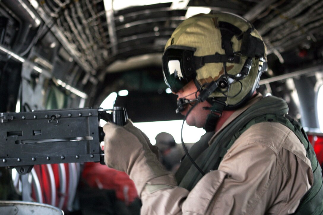 Gunnery Sgt. Brian T. Rogers, 33, an aerial gunner and maintenance controller with Marine Medium Helicopter Squadron 165 (REIN), and native of Virginia Beach, Va., fires a .50-caliber machine gun at a target during a live-fire exercise here. HMM-165 (REIN), attached to the 15th Marine Expeditionary Unit (Special Operations Capable), is training in Kuwait to maintain their skills as an Aviation Combat Element.
