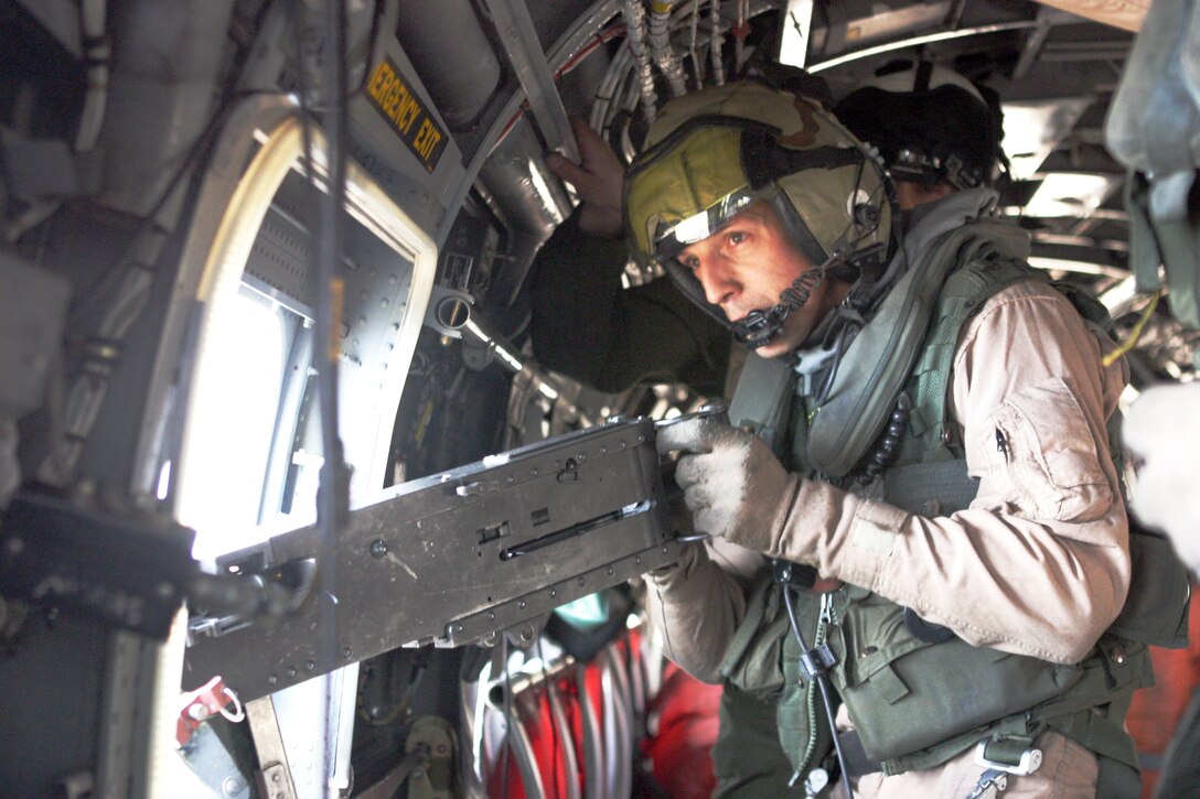 Gunnery Sgt. Lonnie L. Shaw, 32, a CH-46E crew chief with Marine Medium Helicopter Squadron 165 (REIN), and a native of Tucson, Ariz., aims a .50-caliber machine gun at his designated target during a live-fire exercise here. HMM-165 (REIN), attached to the 15th Marine Expeditionary Unit (Special Operations Capable), is training in Kuwait to maintain their skills as an Aviation Combat Element.