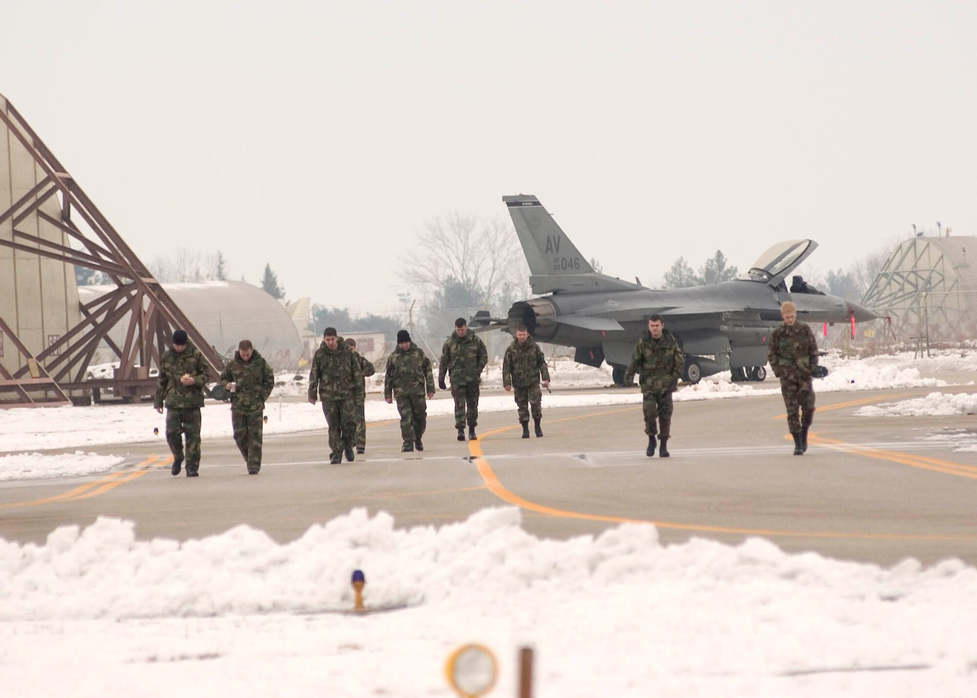 AVIANO AIR BASE Italy -- F-16 Fighting Falcon crew chiefs look for debris on the taxiways here a couple hours before launching F-16s.  Loose debris can damage jet engines.  The Airmen are assigned to the 31st Aircraft Maintenance Squadron here.  (U.S. Air Force photo by Master Sgt. John E. Lasky)