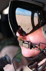 OVER IRAQ -- Senior Master Sgt. Dennis Martin rides in an Army UH-60 Blackhawk  to  document Ashura in Iraq on Feb. 19.  Ashura, the 10th day of Moharram, is when thousands gather to mourn the killing 13 centuries ago of Imam Hussein, the grandson of Prophet Mohammed.  Ashura is the holiest day in the Shiite calendar. This is the second year for this event here because former president Saddam Hussein had not allowed Shias to participate for more than 30 years. Sergeant Martin is a videographer from the 4th Combat Camera Squadron. (U.S. Air Force photo by Master Sgt. Dave Ahlschwede)