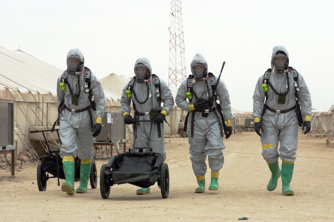 Marines attached to the 15th Marine Expeditionary Unit (Special Operations Capable), head back to their decontamination area after completing an Enhanced Nuclear Biological and Chemical Defense exercise here. The 15th MEU (SOC) is training in Kuwait to sharpen their skills as a Marine Air Ground Task Force.