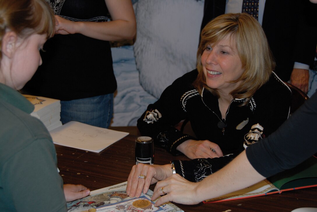 Jan Brett, author and illustrator, signs her newest book for those who attended the signing at Barnes and Noble Thursday. More than one hundred people showed up and the proceeds from the book signing are going to Marine Corps Community Services.