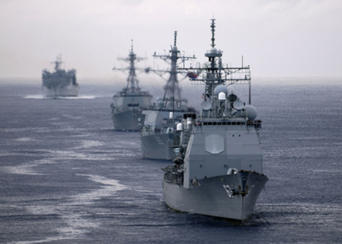 The USS Shiloh (CG 67), USS Benfold (DDG 65), USS Shoup (DDG 86), and USNS Rainier (T-AOE 7) steam behind the aircraft carrier USS Abraham Lincoln (CVN 72) in the Pacific on Feb. 25, 2005. The Lincoln Carrier Strike Group is returning from a deployment to the Western Pacific Ocean en route to their homeport of Everett, Wash. 