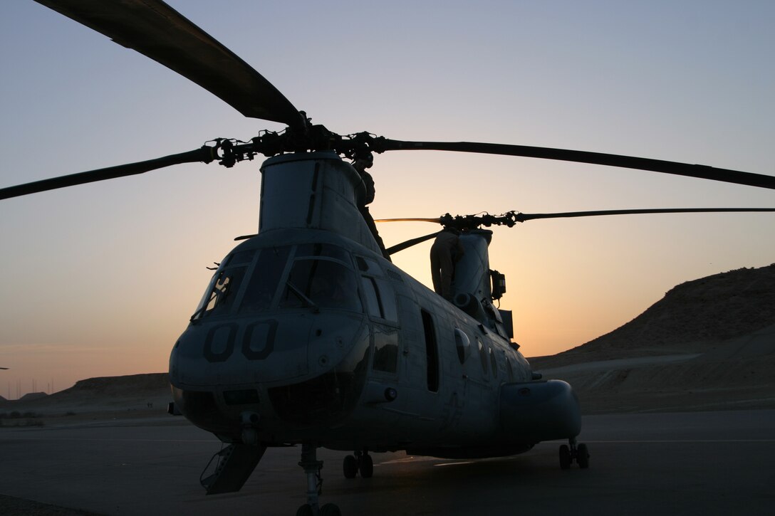 A Marine Medium Helicopter Squadron 264 CH-46E sits on the flightline at sunrise aboard Al Asad, Iraq