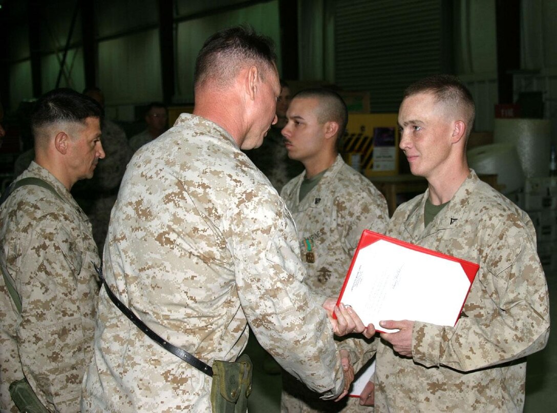 Sergeant Daniel M. Rangel and Lance Cpl. David C. Boone Jr., both machinists with Marine Aviation Logistics Squadron 26, stationed at Al Asad, Iraq, were both awarded Navy Marine Corps Achievement Medals for building, from raw metal, tronion adapters needed to pull engines from AV-8B Harriers to be serviced.