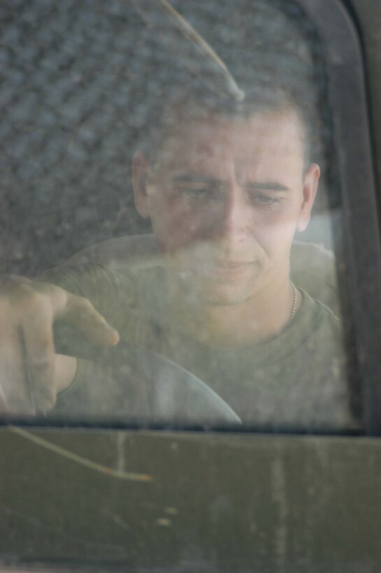 CAMP HURRICANE POINT Ar Ramadi, Iraq (April 1, 2005) -Twenty-seven-year-old Pfc. David S. Johnson, a motor transportation mechanic with Headquarters and Service Company, 1st Battalion, 5th Marine Regiment, fires up a Humvee at the motor pool here before driving it out and pulling another one in to perform preventative maintenance on it. The New Baltimore, Mich., native joined the Marines to honor his late father, Steven R. Johnson, who past away in 2003. His dad was also a mechanic who served in the Corps for more than 20 years. Photo by Cpl. Tom Sloan