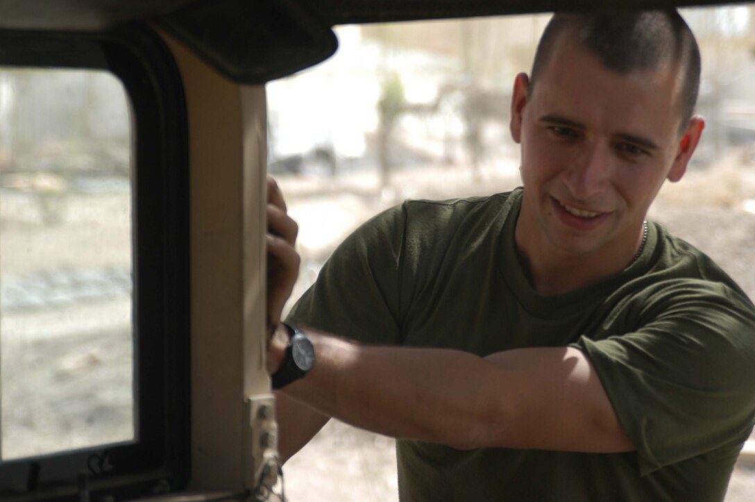 CAMP HURRICANE POINT Ar Ramadi, Iraq (April 1, 2005) -Twenty-seven-year-old Pfc. David S. Johnson, a motor transportation mechanic with Headquarters and Service Company, 1st Battalion, 5th Marine Regiment, installs protective armor on the passenger's side of a Humvee at the motor pool here. The New Baltimore, Mich., native joined the Marines to honor his late father, Steven R. Johnson, who past away in 2003. His dad was also a mechanic who served in the Corps for more than 20 years. Photo by Cpl. Tom Sloan