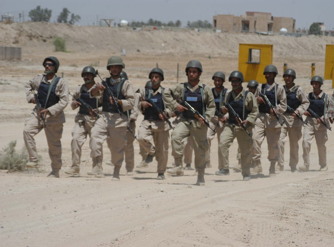CAMP ALI Ar Ramadi, Iraq - Iraqi Security Forces march in formation during a training session here. Marines with the Combined Action Platoon, Company B, 1st Battalion, 5th Marine Regiment, are responsible for training new members of the Iraqi Security Forces during the infantry battalion's deployment in support of Operation Iraqi Freedom.  Photo by: Cpl. Tom Sloan