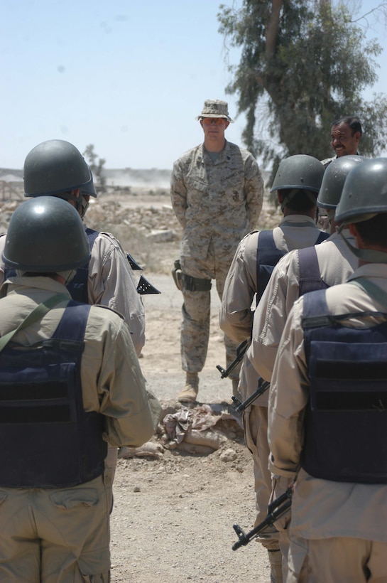 CAMP ALI Ar Ramadi, Iraq - Sergeant Eric K. Stuart, a rifleman and training noncommissioned officer with the Combined Action Platoon, Company B, 1st Battalion, 5th Marine Regiment, stands in front of an Iraqi Security Forces formation during a training session here. The 27-year-old Albuquerque, N.M. and his fellow Marines with the platoon are responsible for training new members of the Iraqi Security Forces during the infantry battalion's deployment in support of Operation Iraqi Freedom.   Photo by: Cpl. Tom Sloan