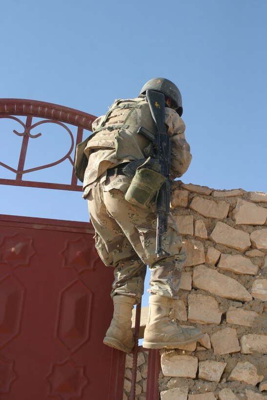 KARABILAH, Iraq- (June 17, 2005)  A member of the Iraqi Security Force prepares to clear a house in Karabilah.  Operation Spear is conducted to destroy insurgency leadership strong points. (Official USMC photo by Cpl Neill A. Sevelius)(RELEASED)