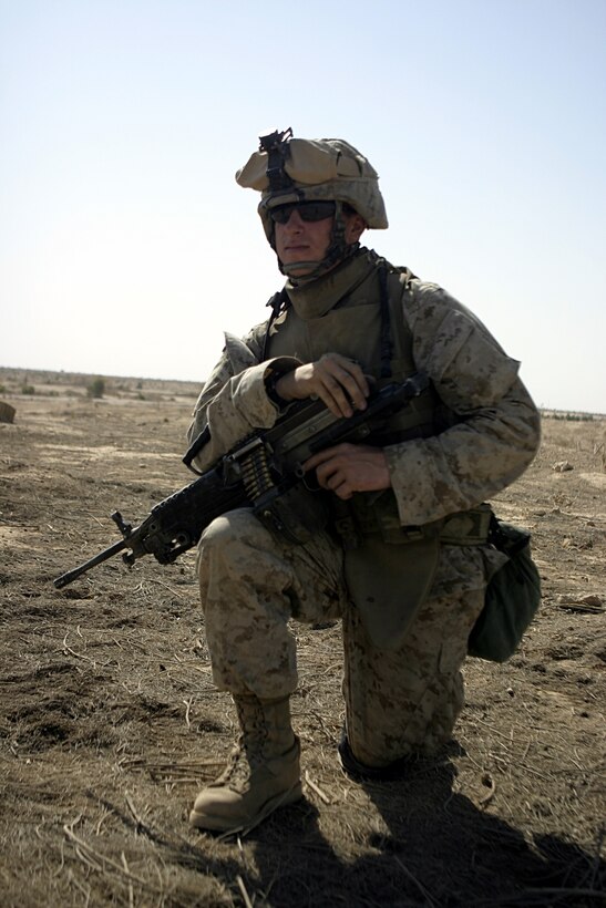 THAR THAR REGION, Iraq - Lance Cpl. Michael Harres, a squad automatic weapon gunner with 2nd Squad, 2nd Platoon, Company B, 1st Battalion, 6th Marine Regiment, provides security for his unit while conducting operations in regions north of Fallujah June 21.  The 19-year-old Brooksville, Fla. native's unit is currently conducting security and stability operations in Iraq's Al Anbar province.