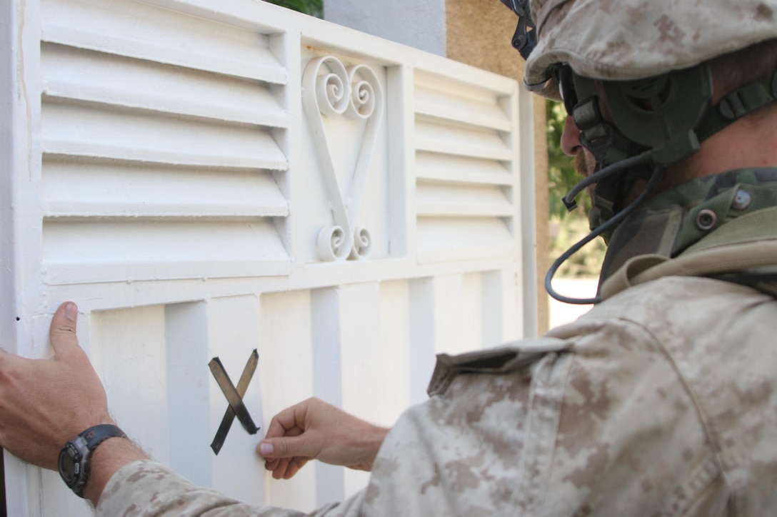 HIT, Iraq (July 1, 2005)- Sgt. James Angelone, a squad leader with 3rd Battalion, 25th Marine Regiment, Regimental Combat Team-2 marks a house during a patrol and cordon and knock in the city during Operation Guardian Sword conducted to clear the city and set-up Iraqi Security Forces firm bases through out the city. The Marines of 2d Marine Division conduct counter-insurgency operations with Iraqi Security Forces to isolate and neutralize anti-Iraqi forces, to support the continued development of Iraqi Security Forces, and to support Iraqi reconstruction and democratic elections in order to create a secure environment that enables Iraqi self-reliance and self-governance. (Official USMC photo by Lance Cpl. Lucian Friel )(NOT RELEASED)