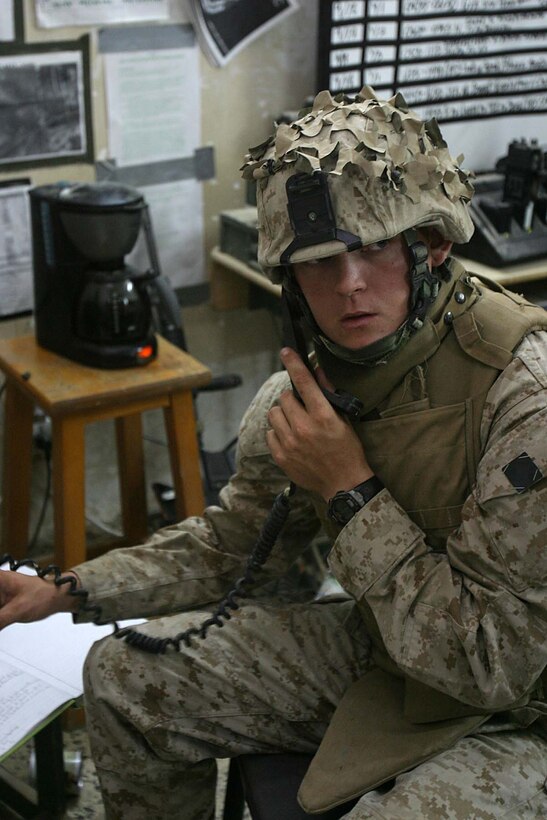 HIT, Iraq (Sept. 18, 2005)  - Corporal Tim R. Kaufmann, a Hillsborough, N.C. native and company radio operator for India Company, 3rd Battalion, 1st Marine Regiment, receives information from patrols after an enemy mortar attack here. As a radio operator, Kaufmann is responsible for connecting the company with the rest of the battalion while part of Operation Iraqi Freedom. (Official Marine Corps photo by Cpl. Adam C. Schnell)