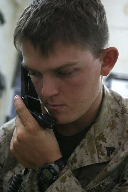 HIT, Iraq (Sept. 18, 2005)  - Corporal Tim R. Kaufmann, a Hillsborough, N.C. native and company radio operator for India Company, 3rd Battalion, 1st Marine Regiment, receives information from routine patrols here. As a radio operator, Kaufmann is responsible for providing current information to the company commander when making battlefield decisions. (Official Marine Corps photo by Cpl. Adam C. Schnell)