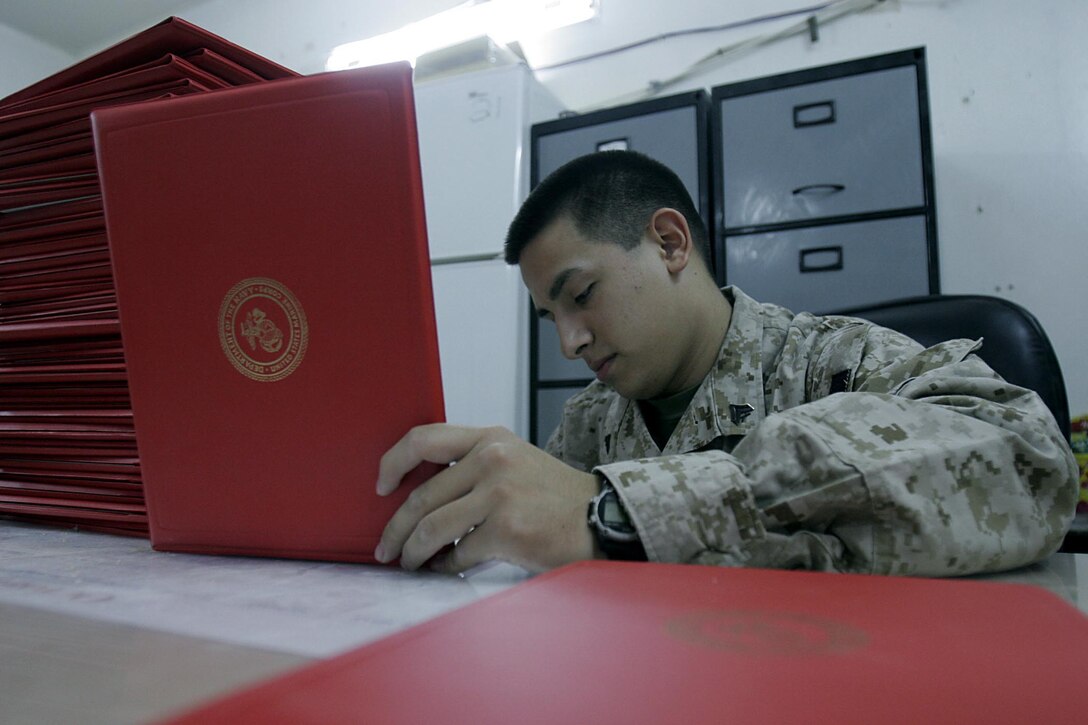 Camp Ripper, Iraq (October 26, 2005)-- Cpl. Paul N. Ibarra, a 20-year-old Brooklyn-Mill Basin, N.Y., native, and Regimental Combat Team-2 administrative clerk reviews awards here. Since February, Ibarra has been handling awards for the unit. (Official USMC Photo by Corporal Ken Melton)