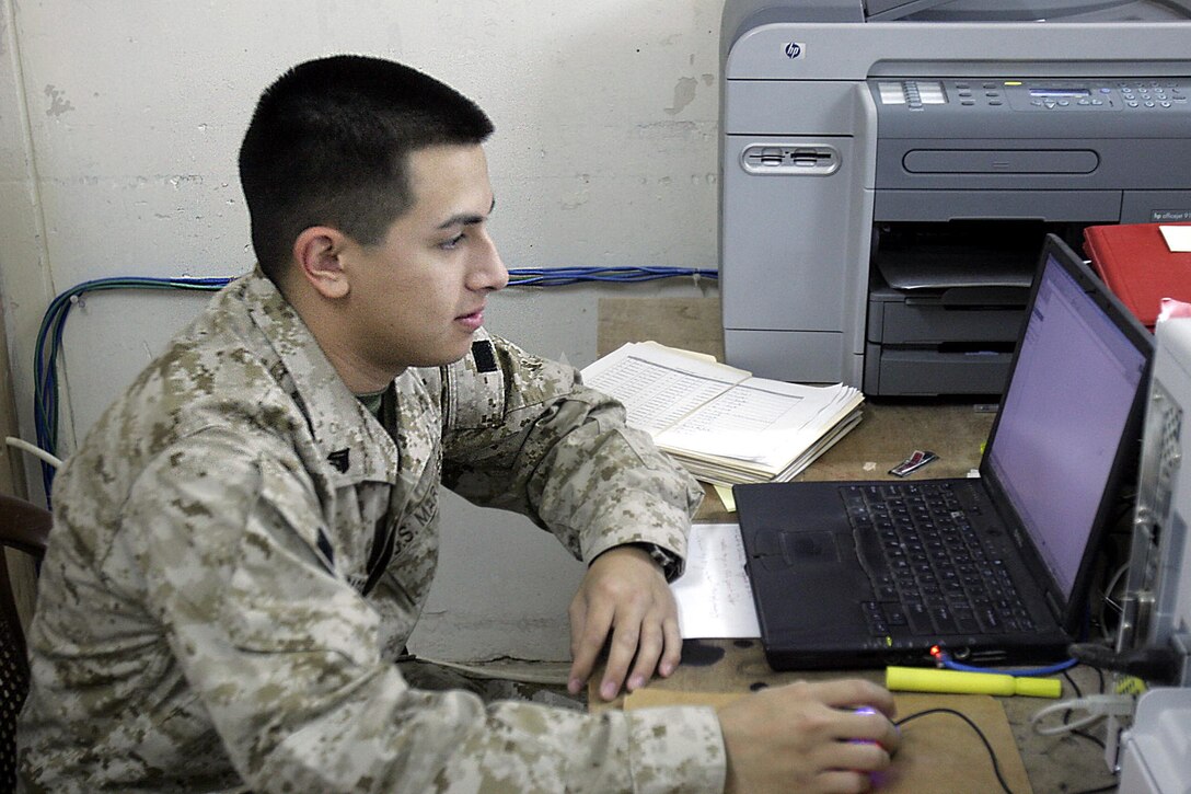 Camp Ripper, Iraq (October 26, 2005)-- Cpl. Paul N. Ibarra, a 20-year-old Brooklyn-Mill Basin, N.Y., native, and Regimental Combat Team-2 administrative clerk checks a program which is constantly updated with awards and other notifications. (Official USMC Photo by Corporal Ken Melton)