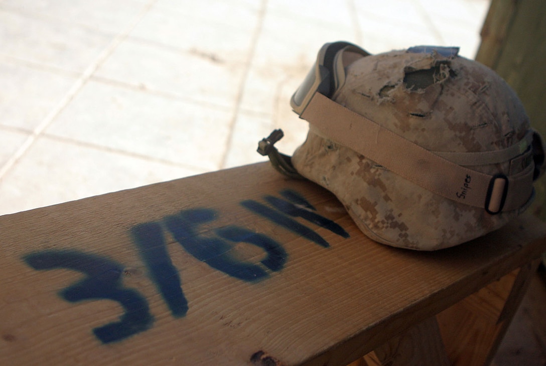 CAMP AL QA'IM, Iraq (Oct. 26, 2005) -- A shot helmet, belonging to Lacey Springs, Ala., native Lance Cpl Bradley A. Snipes, antitank assaultman, 3rd Mobile Assault Platoon, Weapons Company, 3rd Battalion, 6th Marines, rests on a benched marked as property of Weapons Company, 3rd Bn., 6th Marines.  (Official U.S. Marine Corps photo by Sgt. Jerad W. Alexander)::n::