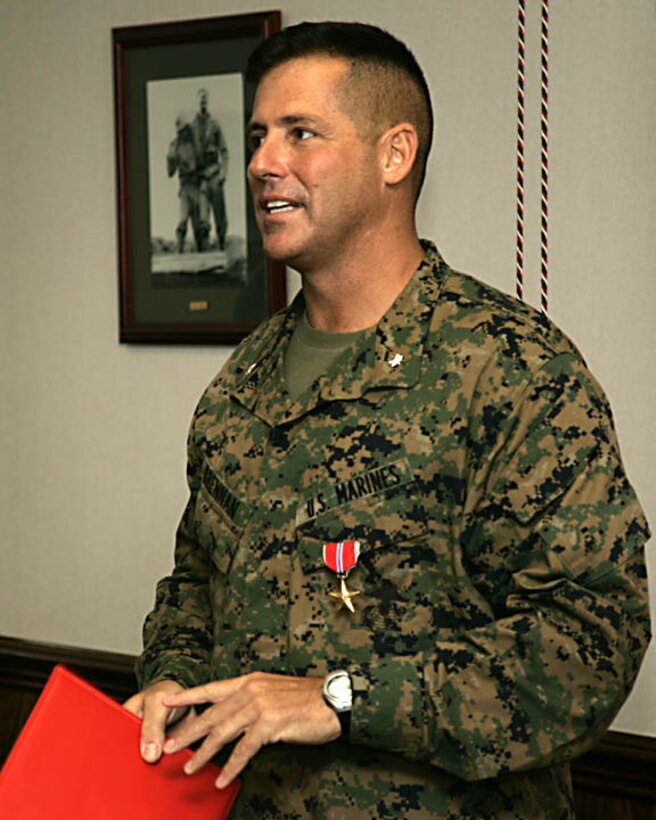 MARINE CORPS BASE CAMP LEJEUNE, N.C. - Lieutenant Colonel Terence P. Brennan, commanding officer for Headquarters Battalion, 2nd Marine Division, addresses some Marines after being presented the Bronze Star Medal here Nov. 1.  The 45-year-old Little Compton, R.I. native received the nation's fourth highest award for his superior leadership while commanding his former artillery unit, 2nd Battalion, 10th Marine Regiment, during a recent deployment to Iraq's turbulent Al Anbar province.
