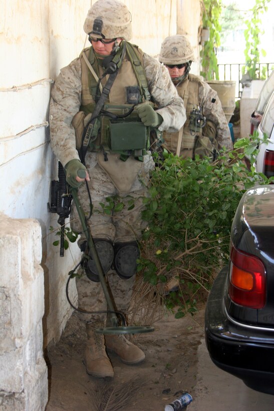 AR RAMADI, Iraq (November 1, 2005) - Lance Cpl. Russell Volk, a combat engineer with 2nd Platoon, Company C, 1st Combat Engineer Battalion, sweeps for possible improvised explosive devices and weapons caches during a raid Nov. 1. Photo by Cpl. Shane Suzuki