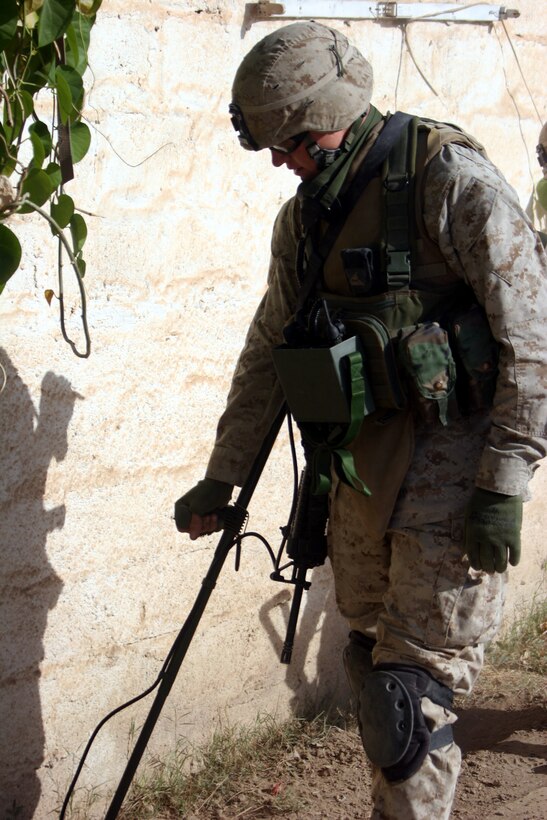 AR RAMADI, Iraq (November 1, 2005) - Lance Cpl. Russell Volk, a combat engineer with 2nd Platoon, Company C, 1st Combat Engineer Battalion, sweeps for possible improvised explosive devices and weapons caches during a raid Nov. 1. Photo by Cpl. Shane Suzuki