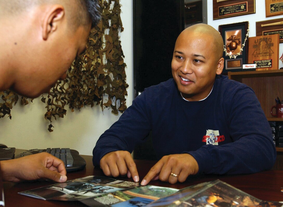 Gunnery Sgt. Elmer G. Pagaragan, 28, Recruiter of the Year for RS Orange County in 2004, discusses the opportunities available in the Marine Corps’ aviation electronics military occupational specialty with Pfc. Richard D. Luis, a Marine recruited by Pagaragan during his award-winning year. (Photo by Lance Cpl. Bernadette L. Ainsworth, Combat Correspondent, Marine Forces Pacific)