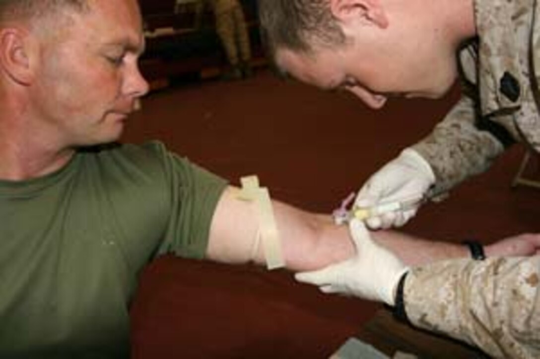 Personifying troop welfare, First Sgt Joe Breze, Wpns. Co., 3rd Bn, 7th Marines, has blood drawn for the Department of Defense Bone Marrow Registry March 1. A registration drive was held to find a donor for Lance Cpl .Chris LeBleu, India Co., 3/7. Breze was LeBleu?s first sergeant while the battalion was deployed in support of Operation Iraqi Freedom 2.