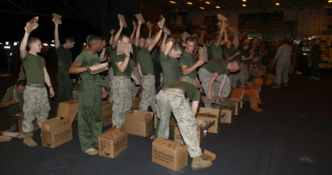 Members of the 15th Marine Expeditionary Unit (Special Operations Capable) prepared hundreds of cases of Meals Ready to Eat as part of a humanitarian effort to reduce the suffering caused by the recent earthquake and subsequent catastrophic events.