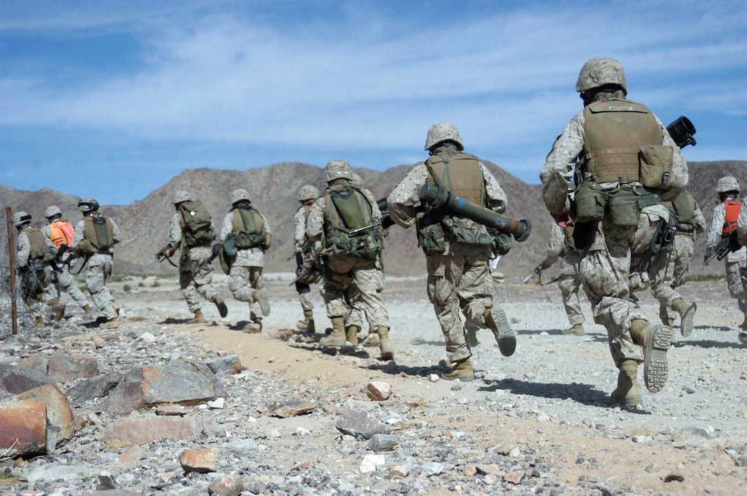Marines of Weapons Company, 3/5, rush from the firing line to begin a live-fire, ground movement exercise at Range 410-A, Twentynine Palms during Mojave Viper Nov. 1.