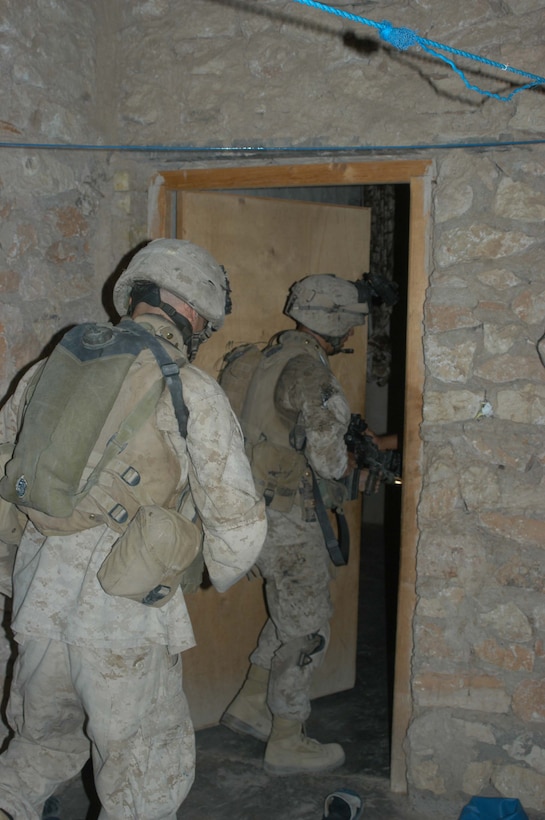 AR RAMADI Iraq (July 2, 2005)  --Lance Cpl. Manuel Valle Jr., a rifleman and team leader with 2nd Squad, 1st Platoon, Company A, 1st Battalion, 5th Marine Regiment, leads the way into a house during a mission in the city here early July 2. The 22-year-old from Parlier, Calif., and fellow Company A Marines conducted a raid in the Al Anbar capital between midnight and 5 a.m. and apprehended three insurgents. Photo by: Cpl. Tom Sloan